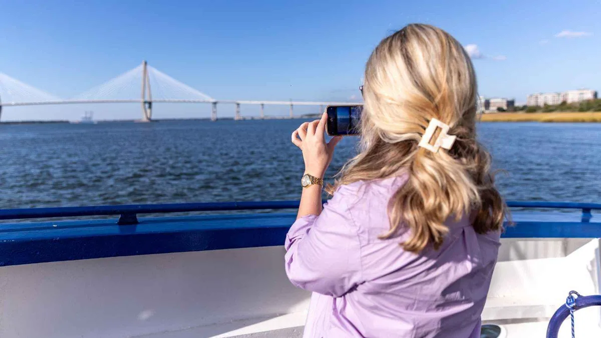 Dolphin watch cruise from Charleston passing the USS Yorktown, a narrated Charleston harbor cruise