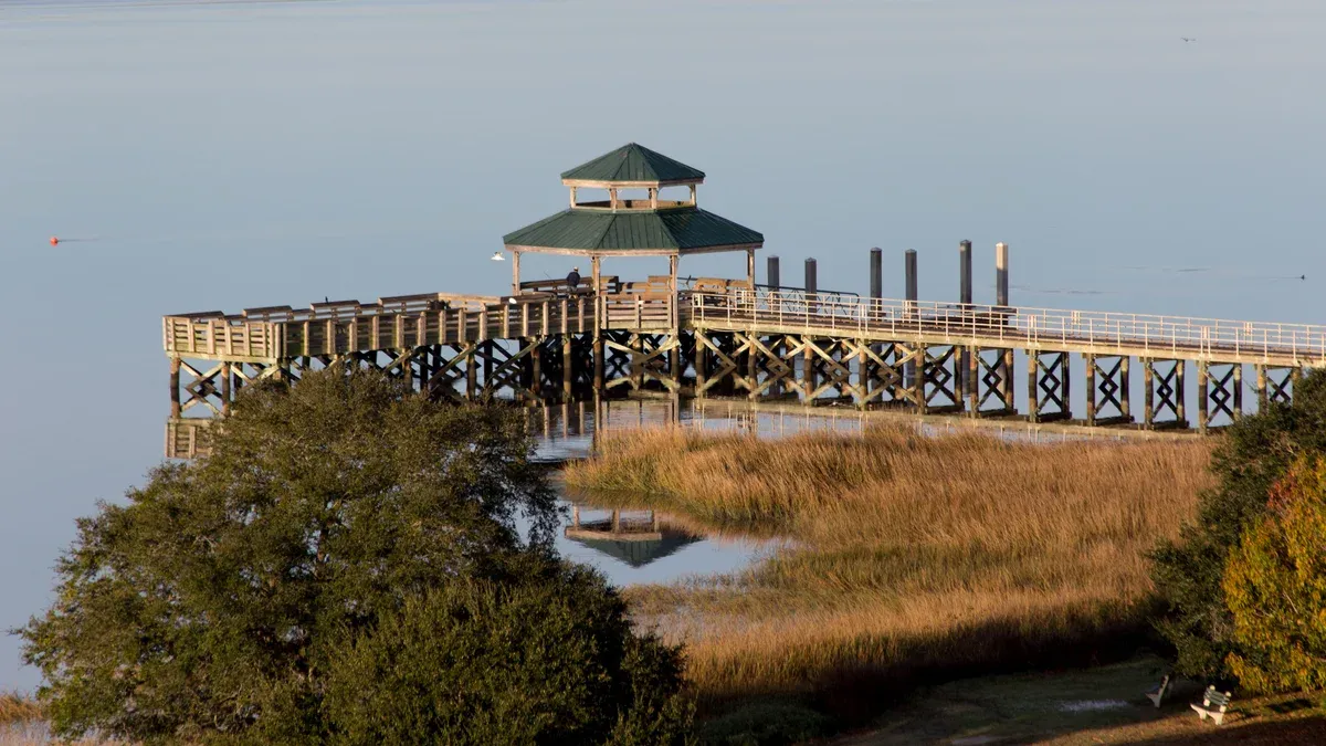 Pier over the marsh on the Ashley River in Charleston, on the water Charleston boat rentals cover