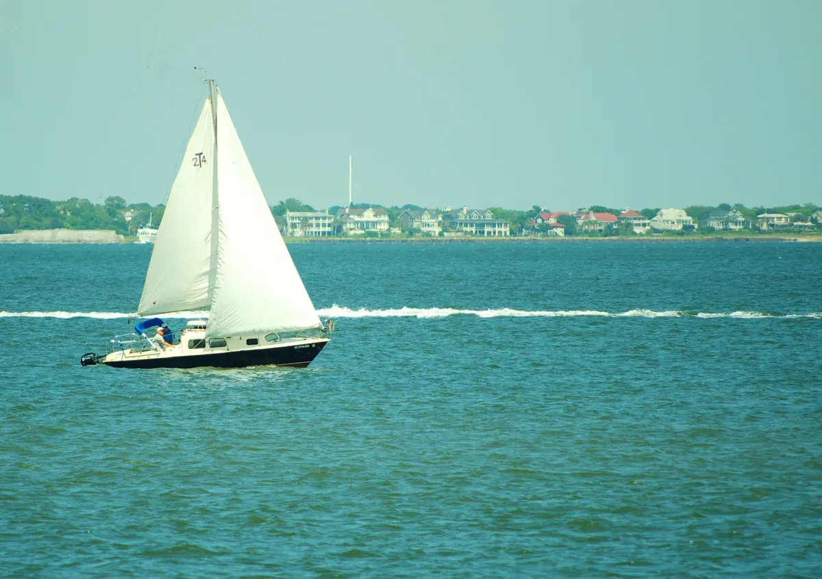 Sailboat under sail in Charleston Harbor, the waters of a private yacht charter in Charleston