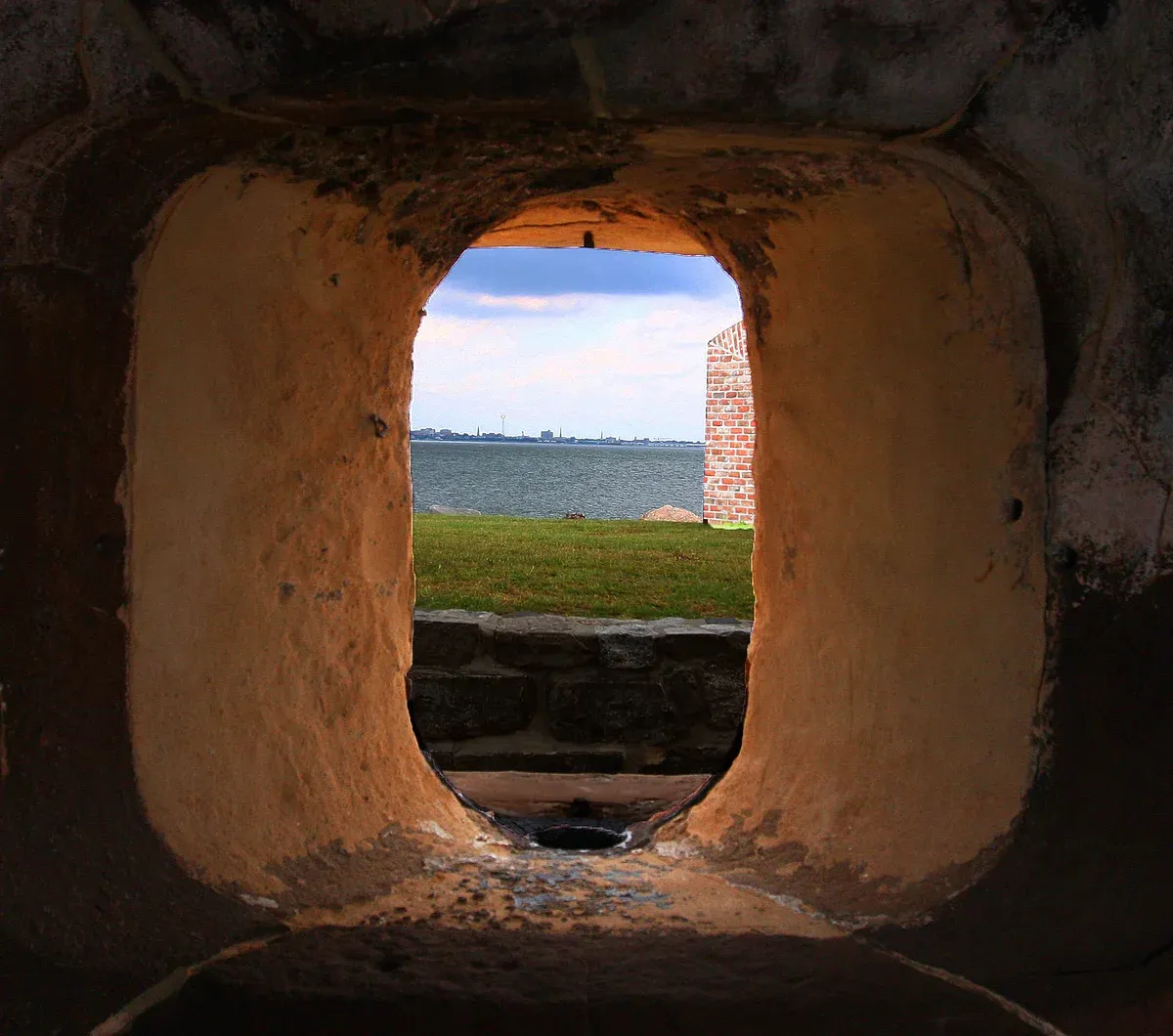 Gun port in a Fort Sumter wall looking over Charleston Harbor, seen on the Fort Sumter ferry tour from Charleston